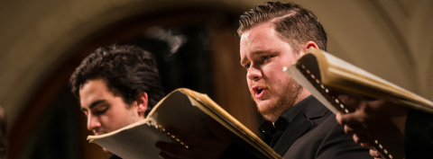 Close-up of two choral singers performing in Redpath Hall, McGill University