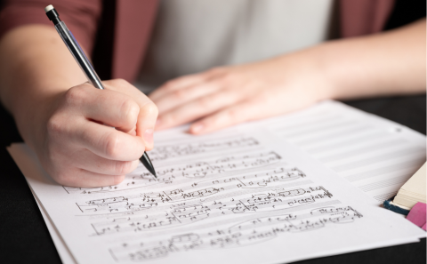 Student working on a music theory assignment with a mechanical pencil