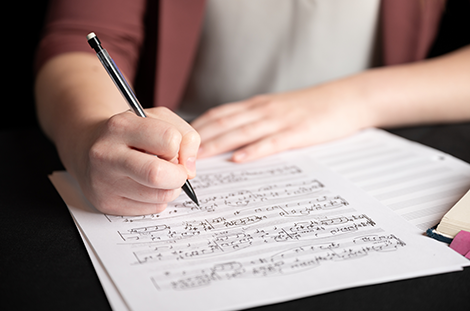 Student holding a pencil over score