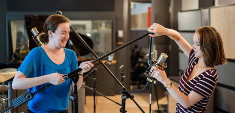 sound engineers playfully holding microphone