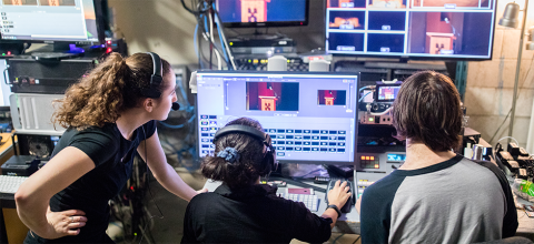 Students looking at sound recording equipment during a performance