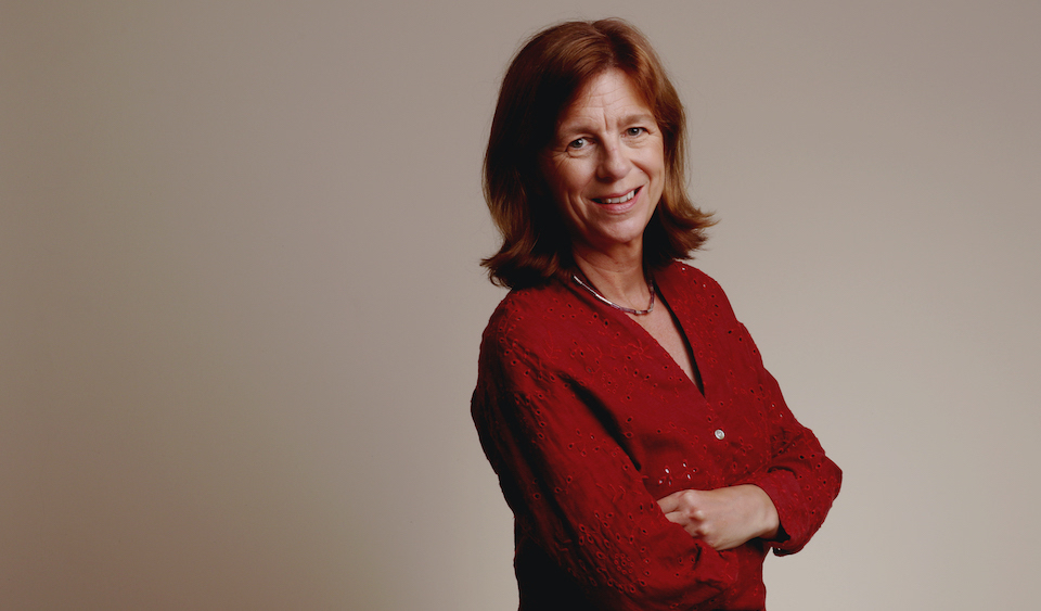 Andrea Creech in front of a grey background