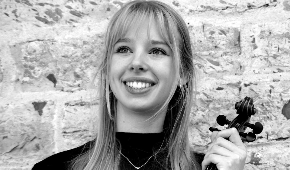black and white photo of Charlotte Van Barr holding her violin