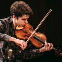 Justin Saulnier playing his violin in Tanna Schulich Hall for the 2024-2025 Golden Violin Award Competition