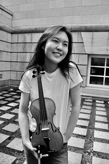 Photo of Yan Li holding a violin