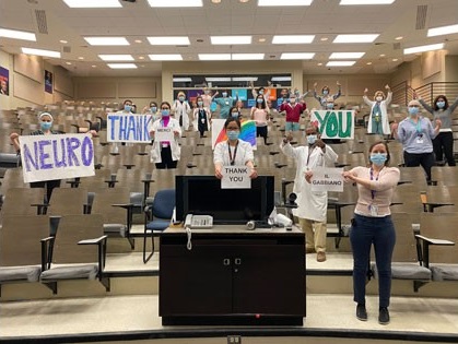 Frontline Neuro Staff in the Jeanne Timmins Ampitheatre holding up "Thank You" signs