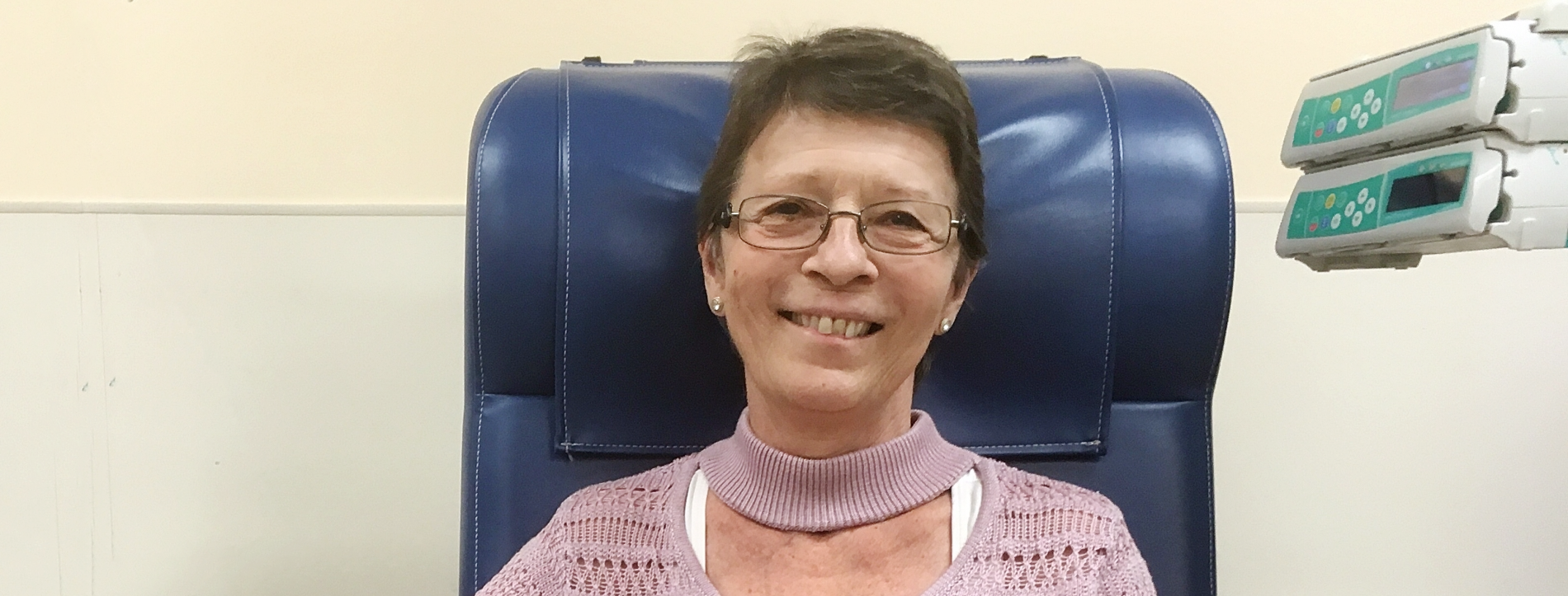 Michelle Dore Sitting in Hospital Chair Smiling