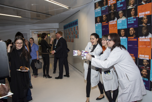 Scientists pose with mugs at campaign event photobooth