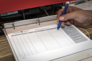 Patient filling out log book