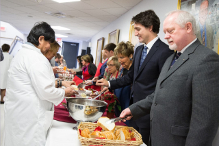 Future PM Justin Trudeau and Dr. Guy Rouleau on the serving line (2014)