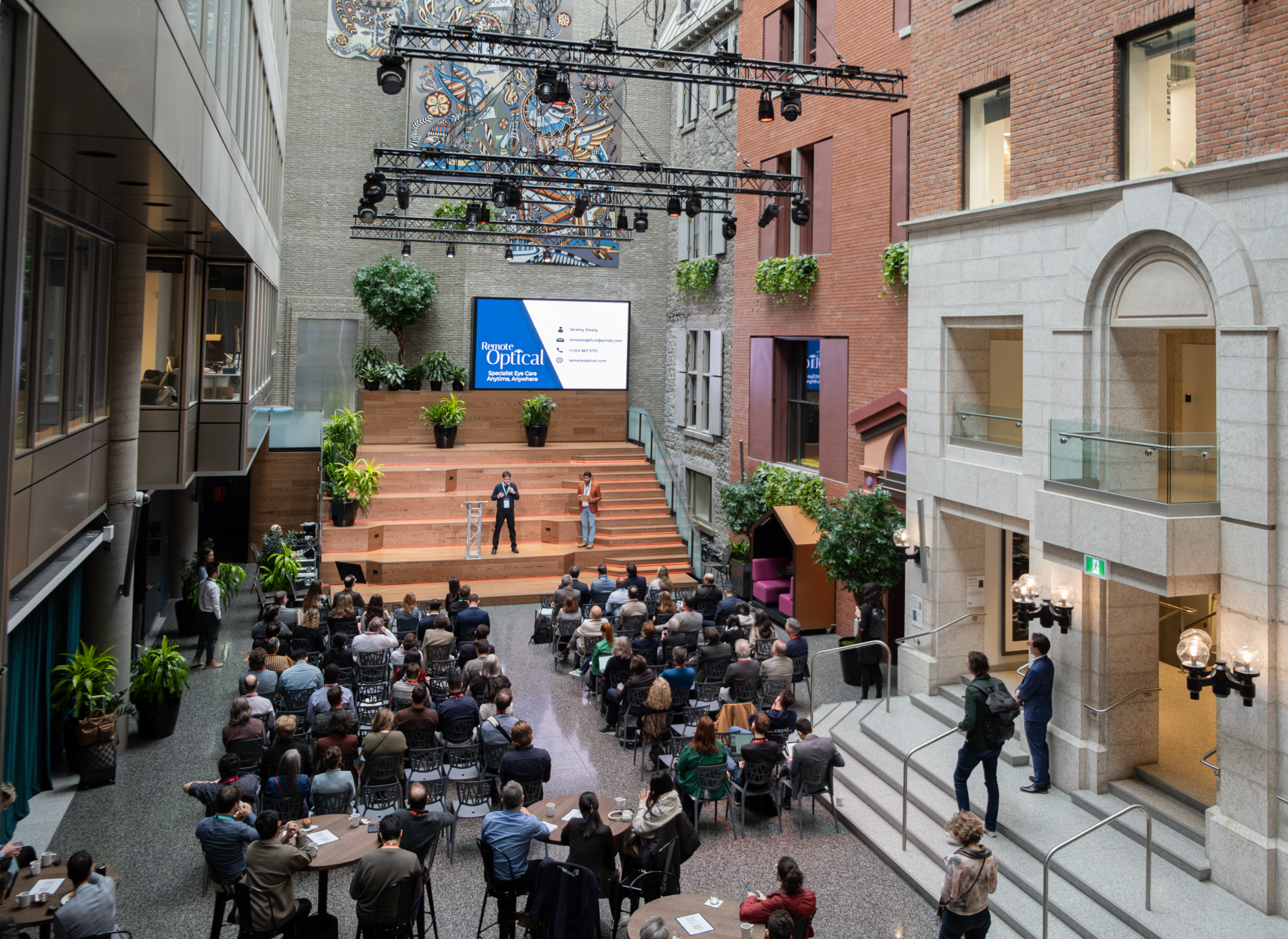 Participants listening to a startup's pitch at Demo Day