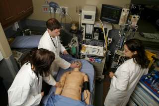 doctors in simulation center practising on a manikin