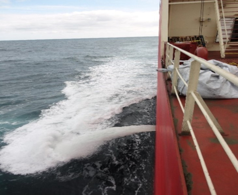 Ship discharging ballast water at sea.