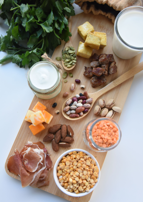 An assortment of protein-rich foods arranged on a cutting board.