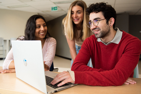 Three nursing students looking at laptop