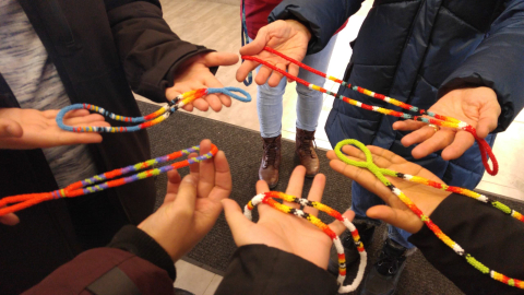 Hands holding beadwork