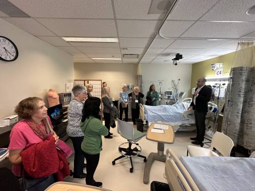 Nursing alumni ask many questions as they tour the Satoko Shibata Clinical Nursing Laboratories during Homecoming 2023,