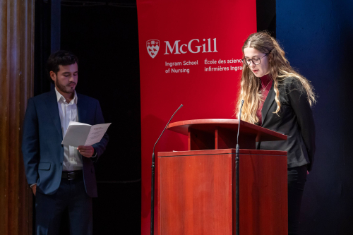 Nursing Undergraduate Society President Noémie Rancourt recites the oath in French while Camilo Sierro Herrera, President of the Nursing Graduate Students Association, looks on.