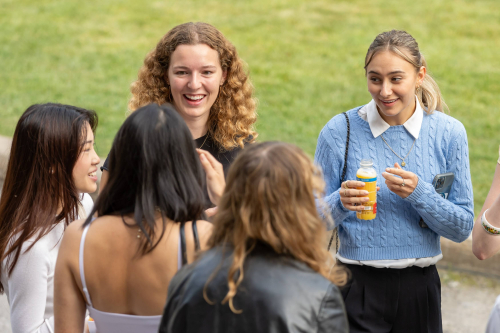 Five students in conversation on the McGill campus grounds following the Nursing Professionalism Ceremony.