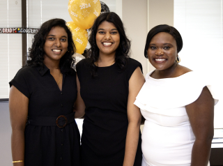 Three women smiling at convocation reception