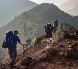 Group of individuals hiking on a mountain.