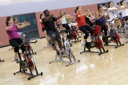 people attending a spin bike class