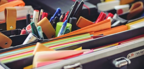Drawer of various office supplies and paper folders