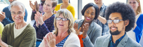 Animated group of individuals attend a conference