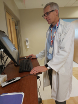 Oncologist at Computer