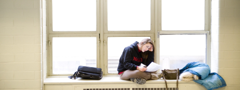 Student sitting on windowsill