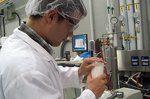 male student working with lab equipment