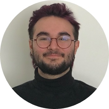 Headshot of Ezrah Isaac Roy, bearded with glasses