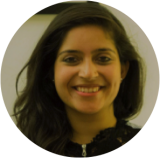 Head-shot of a smiling Professor Pallavi Sirjoosingh wearing a black top.