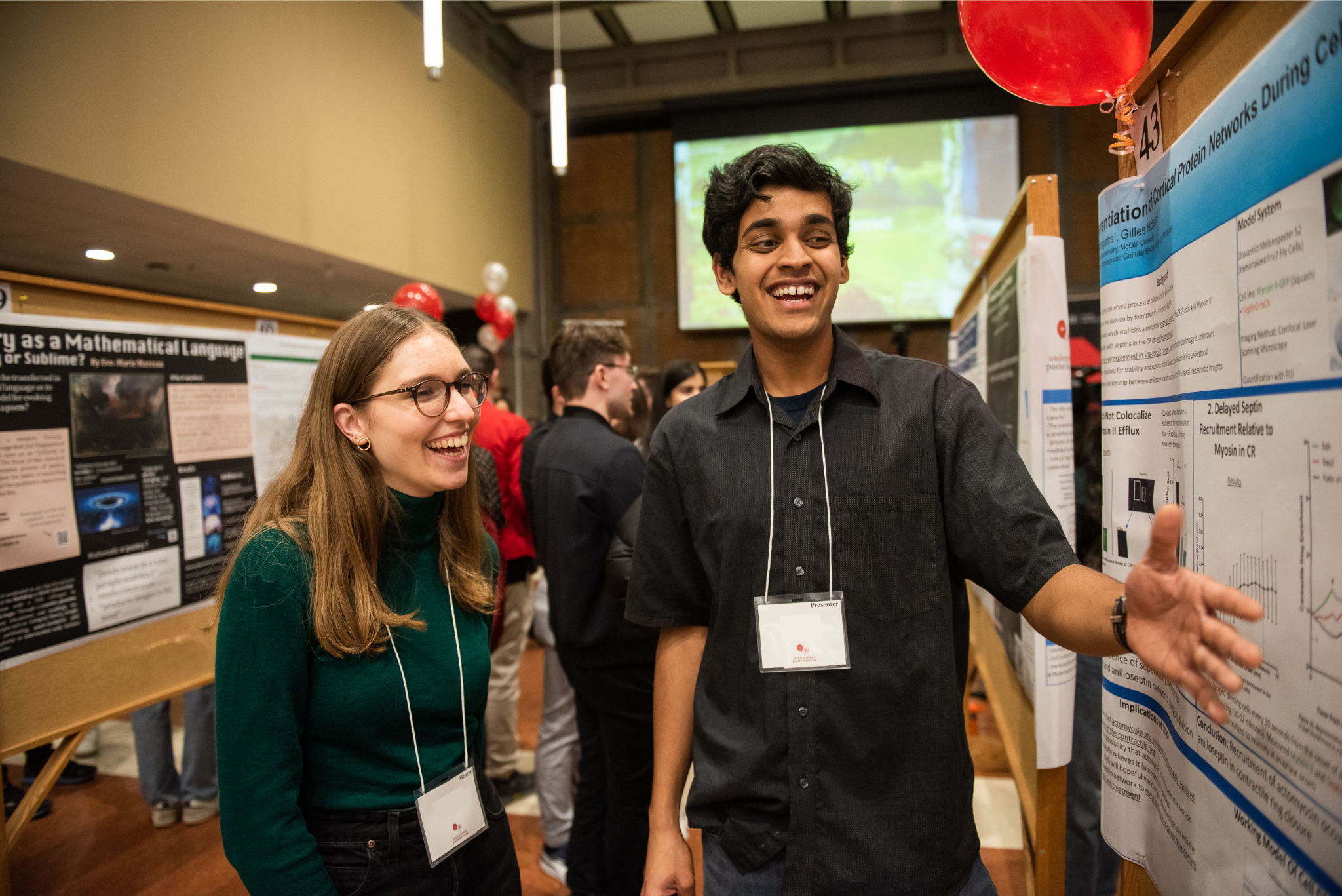 Two people looking at a poster