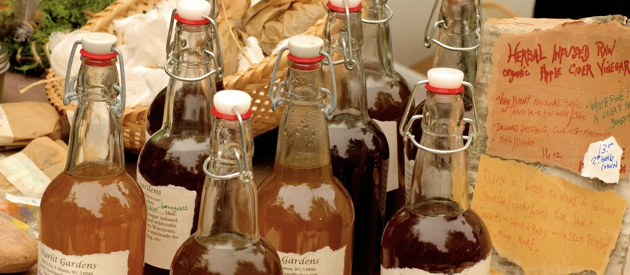 Market-style assortment of bottled organic apple cider vinegar.