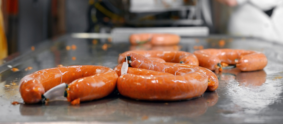 Packaged sausage on an assembly line.