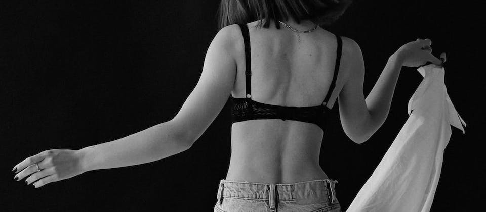 Back View of Woman in Bra in Black and White