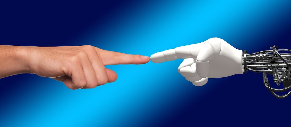 Human hand pointing to a robot mechanical hand
