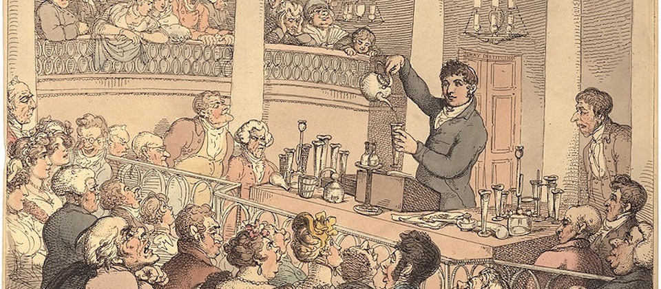 person pouring liquid from a teapot in a chemical lecture