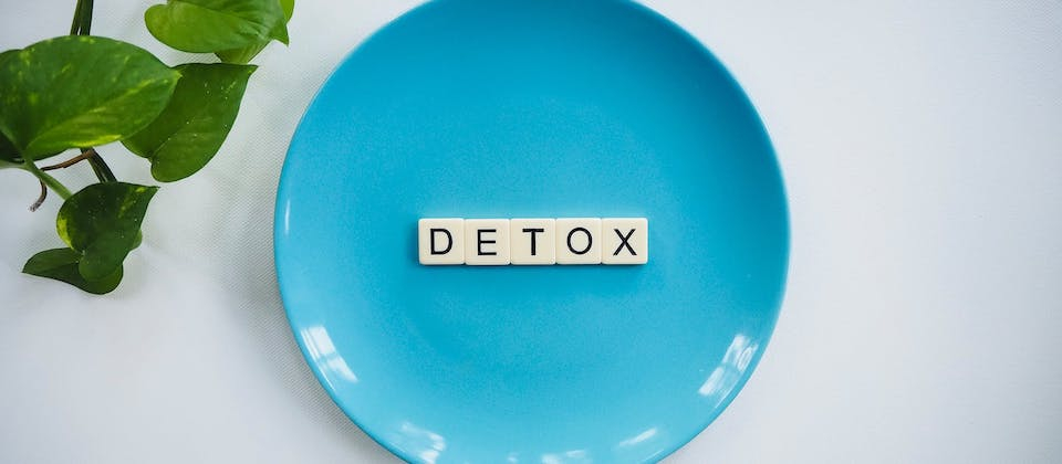 detox spelled on a plate