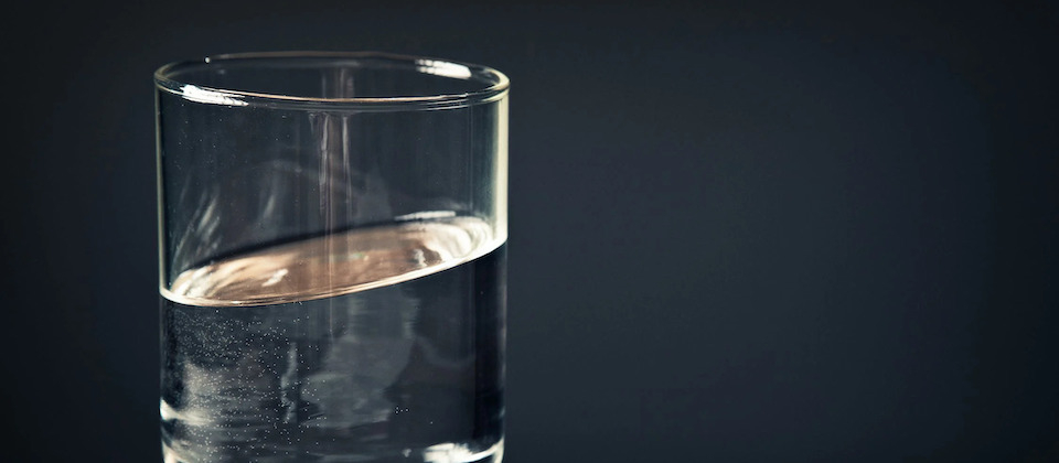 glass of water against dark background