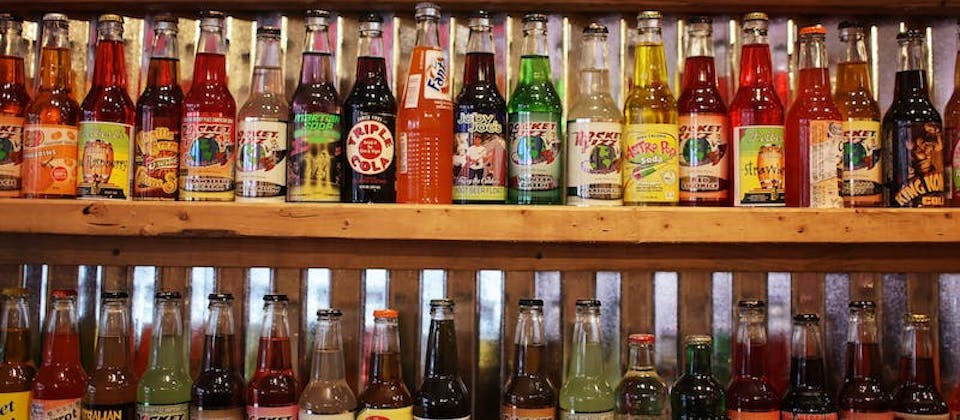 Colorful bottles of soda pop on store shelf