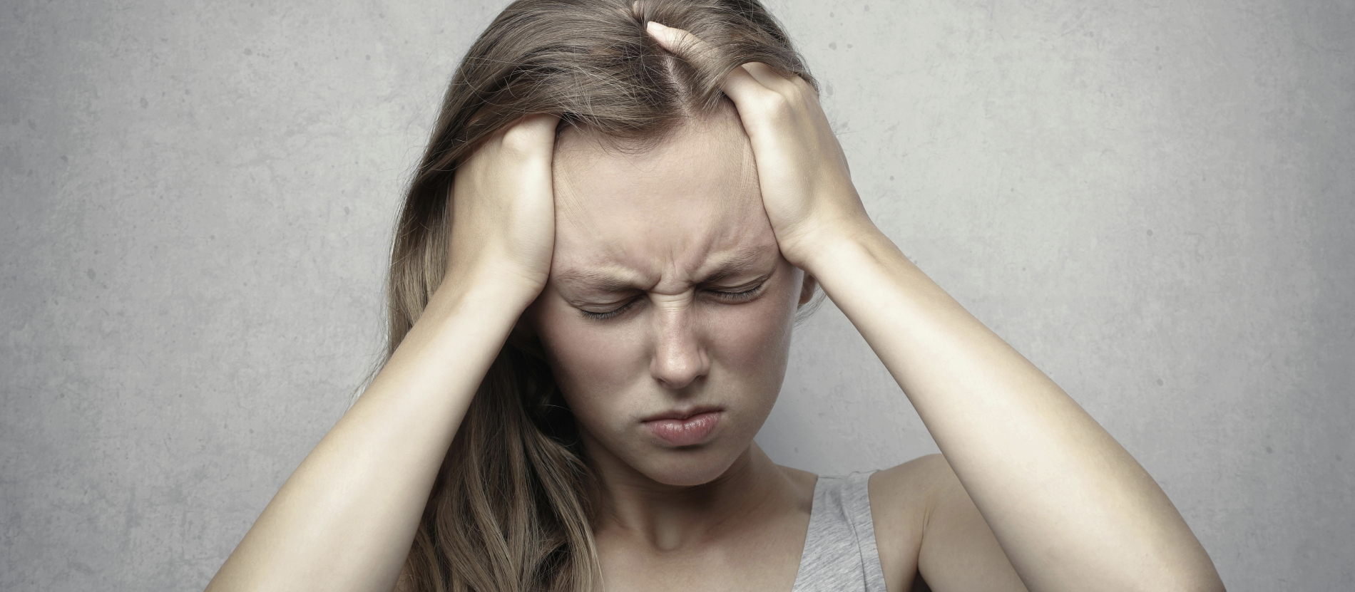 woman holding her head in frustration