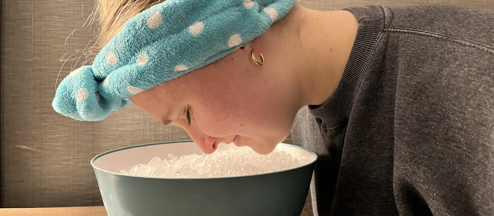 girl hovering her face over an ice bath
