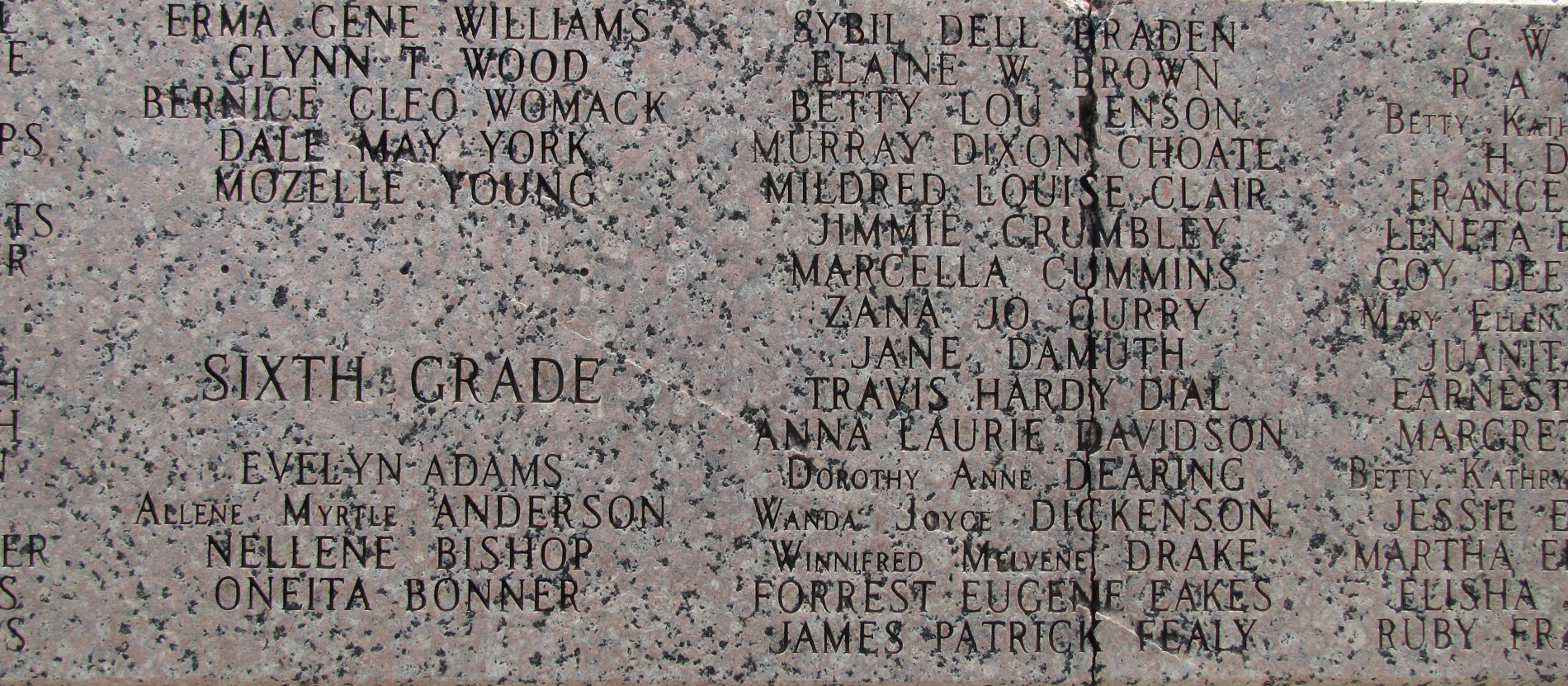 Names carved into the New London School memorial.