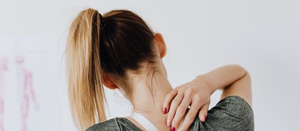 woman holding embracing neck due to pain
