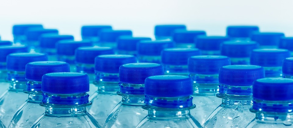 many blue plastic bottle caps lined up