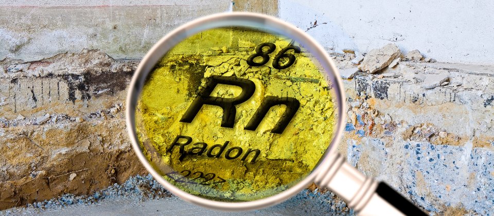 Magnifying glass showing the radon element symbol against a cracked wall