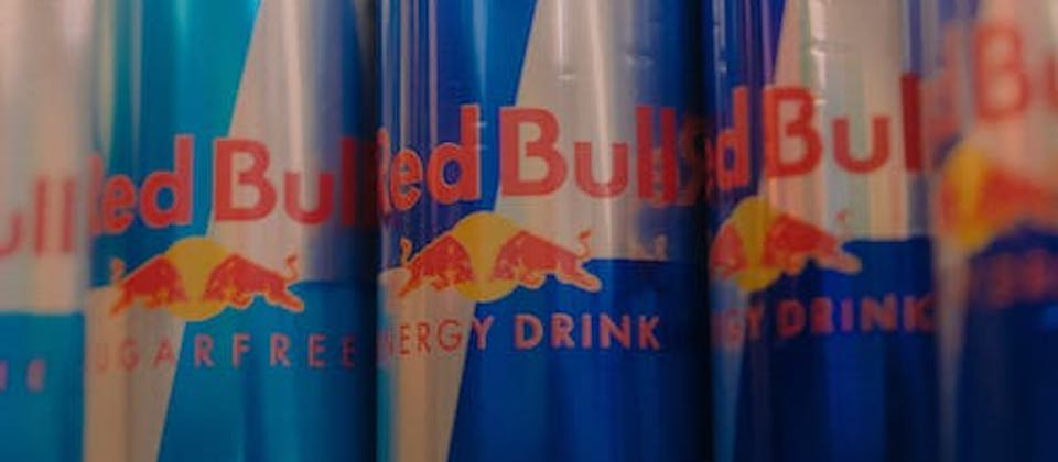 close up of cans of red bull energy drink containing taurine