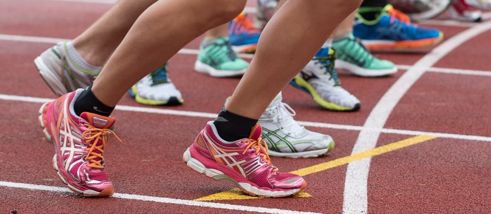 close-up of runners feet at the start line of a track